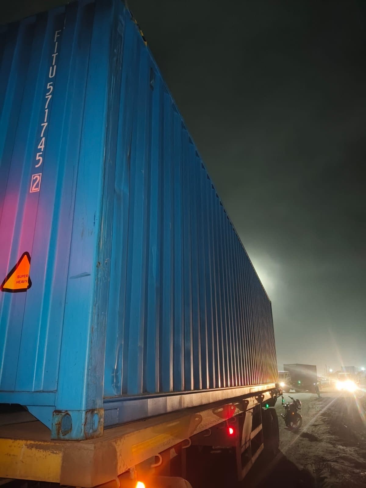 Shipping container on a road trailer during delivery and inspection attendance