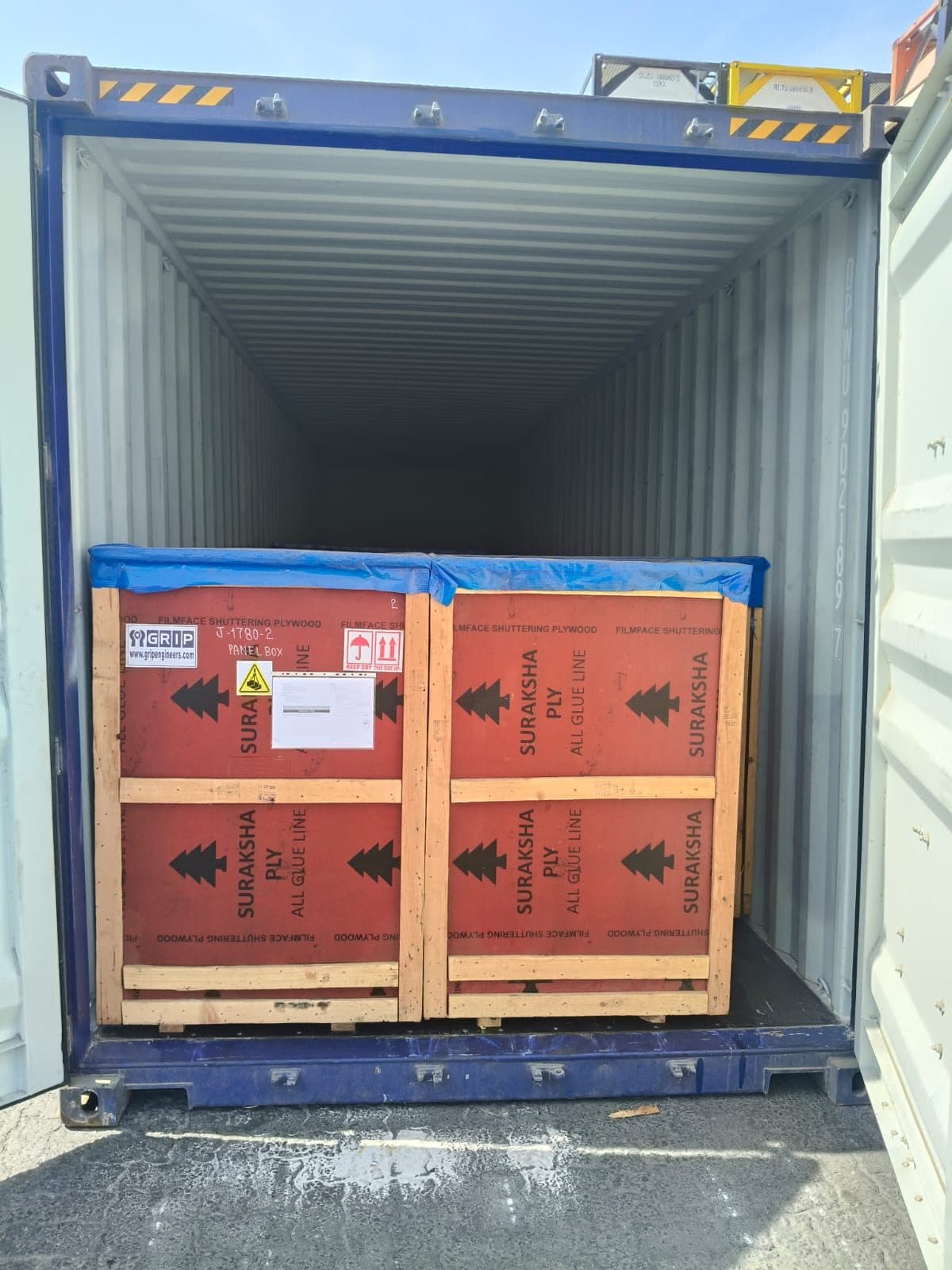 Packed crates loaded at the door of a shipping container